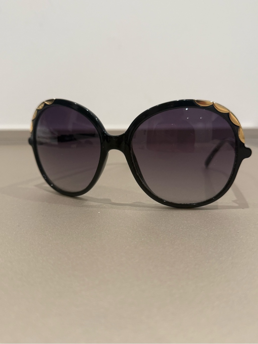Chloe Black Round Sunglasses with Gold Petal Accents